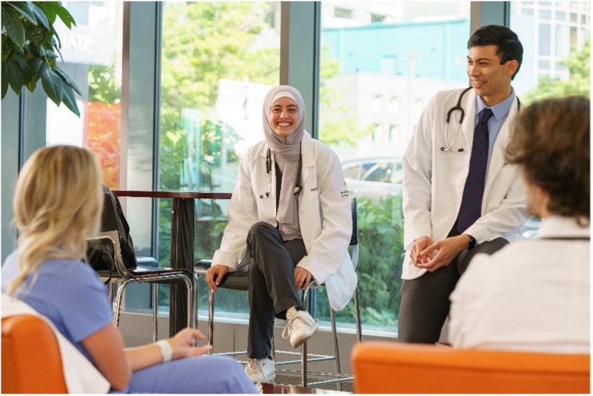 female student smiling and talking with other students